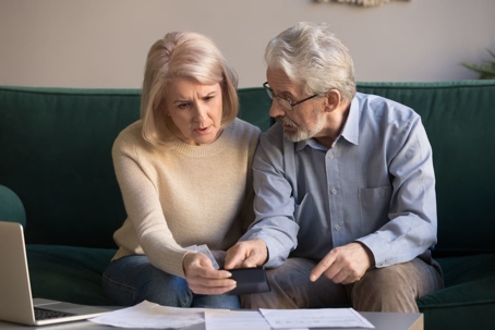 Elderly couple looking at documents