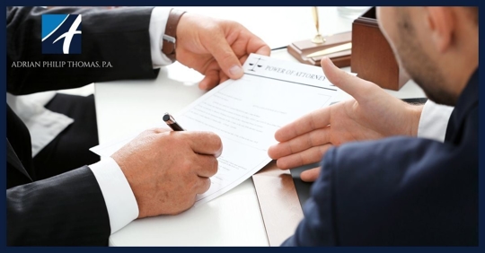 Man holding document and another man pointing at it